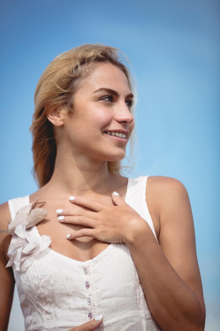 woman smiling with hand on heart
